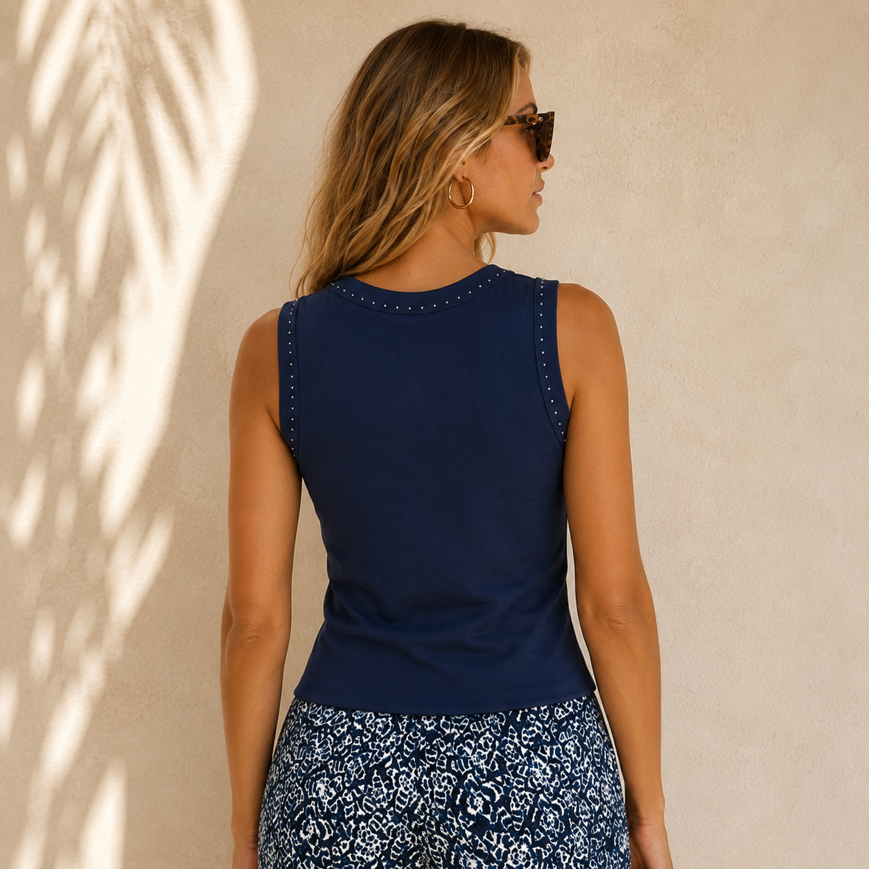 The Nic + Zoe Perfect Rib Knit Studded Tank brings an elevated touch to a timeless everyday essential. Designed in Nic + Zoe’s loved ribbed cotton-modal blend, this tank offers a soft, drapey feel with just the right amount of stretch for all-day comfort.

A higher neckline and subtle yoke seaming create a polished, flattering shape, while placed silver stud accents add a refined hint of shine. Easy to wear on its own or layered under a jacket or cardigan, this versatile knit tank is perfect for dressing up